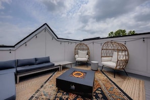 Rooftop deck with outdoor seating and firepit
