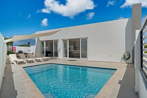 - Dive into your private pool under the clear blue sky for the ultimate vacation vibe - Sunbathe in comfort on the poolside loungers, surrounded by privacy walls for a secluded retreat - Perfect setting for a relaxing getaway with friends or family