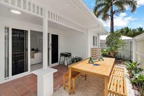 A sprawling outdoor area takes advantage of the North Queensland climate, with a BBQ and dining setting for laidback alfresco meals.
