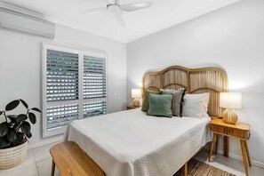  The thoughtfully furnished second bedroom includes a queen-size bed with side tables and reading lamps, with split system air conditioning and ceiling fans in all three bedrooms ensuring year-round comfort. 
