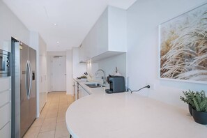 Enjoy home-cooked meals in the apartment with a well-equipped kitchen and a two-door fridge. 