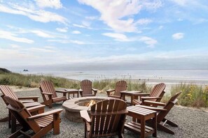 Unwind fireside as the serene sounds of the ocean provide the perfect backdrop.