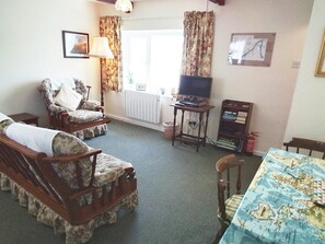 Living and dining area with table and chairs and tv
