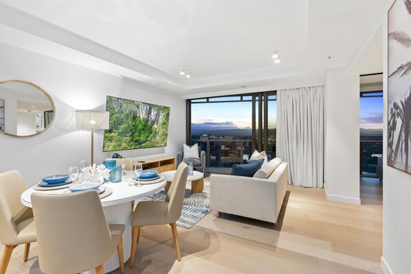 The elegant dining area is right next to the living area and the balcony