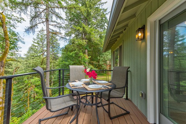 Enjoy outdoor dining with beautiful views of trees and river.
