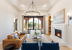 Second Living Area with designer furnishings, a fire place, and access to the backyard patio.