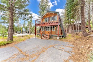 Exterior: View of the front of the home, upper and lower level decks, driveway with parking for 2 cars
