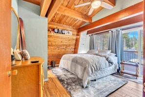 Bedroom 1: King bed, closet, dresser, sliding door to upper floor deck, access to shared half-bath, upper floor
