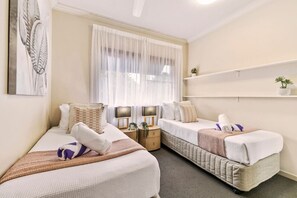 Bedroom  with two single-size bed, wardrobe, aircon and ceiling fan