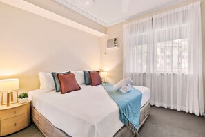 Master bedroom with king-size bed, wardrobe, aircon and ceiling fan