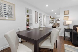 The dining table has seating for six and is near the bunk bed rooms.