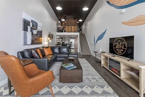 The unit has an open floor plan with the bedroom in the loft upstairs.