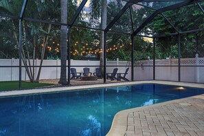 Enjoy a magical evening by the pool, illuminated by string lights and cozy up by the fire pit for a perfect night under the stars