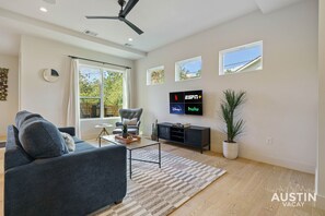 Living room with sleeper sofa, smart tv, natural lighting, and more