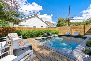 Beautiful heated pool deck, grill/ smoker, lounge chairs, and more just outside the back door!