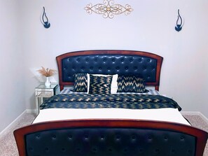 A beautiful large King bed in a Master Suite with bathtub and shower downstairs