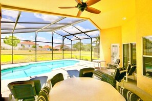 A large covered lanai shares a space for al fresco dining