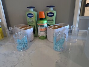 Lotion, mouthwash, and floss/picks provided at the bathroom sink