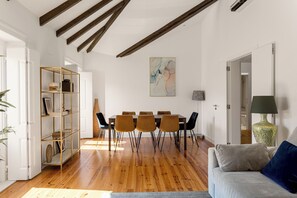Living room, balcony, sofa-bed, tv, and dinning table.