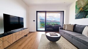 The Blissful Suite living room offers comfort with a smart TV, cozy seating, and free WiFi, perfect for relaxation. #luxury #primelocation