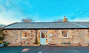 Front of The Stables, 2 private parking spaces and walled garden to rear