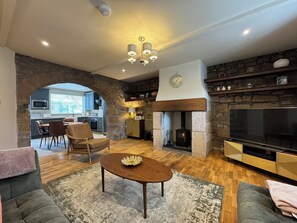 Living Room with real wood burner, corner sofa, chair, Smart TV with Netflix and Soundbar. (1)