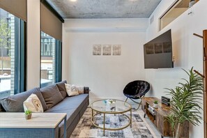 [Living area] 55" Smart TV with Netflix & Queen sleep sofa