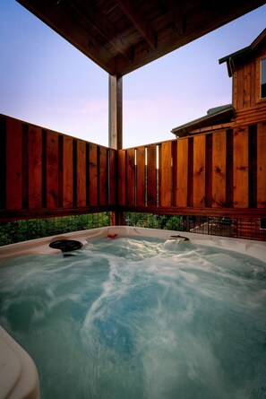 The spacious hot tub on the lower deck bubbles invitingly and can fit 7 adults.