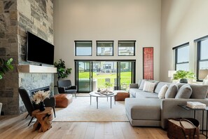 Living room with a 75" LG smart TV and gas fireplace