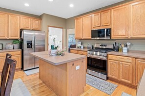 The open kitchen is fully stocked with cookware, dinnerware, cooking essentials including coffee at Minne-Getaway: Timber Ridge.