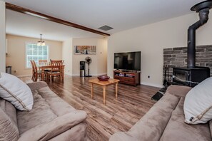 Relax in the comfortable living space, complete with plush seating, a smart TV, and a cozy fireplace, perfect for unwinding after a day of adventure.