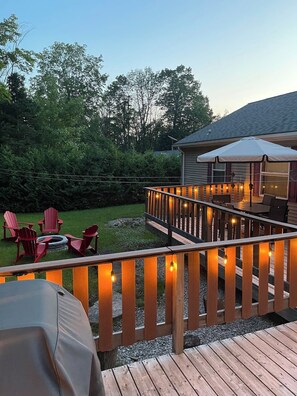Gather around the fire pit for relaxing evenings, with the deck’s glowing lights adding a magical ambiance to your outdoor experience.