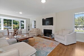 Spacious Living Room with game table, piano, and fireplace 
