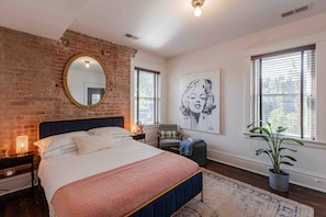 The chic bedroom four gives you a NYC loft style space with exposed brick walls