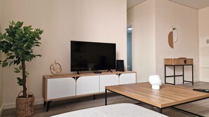 Relax in the cozy living area featuring a large smart TV and high-speed WiFi. Perfect for unwinding after a day exploring Funchal, streaming your favorite shows, or working remotely. #modern #freewifi