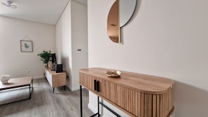 A welcoming entryway with sleek, modern finishes, and ambient lighting. The entrance leads directly into the bright and spacious living area, setting the tone for a comfortable stay.