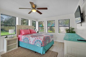 Main bedroom with a queen bed, smart TV and private bathroom