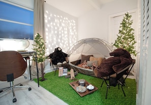 Camping game room with tent set up and dedicated workspace
