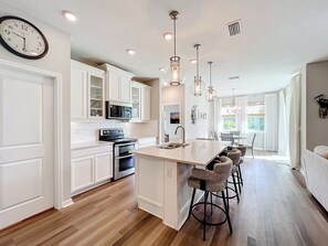 Stunning open concept kitchen with large island and barstools