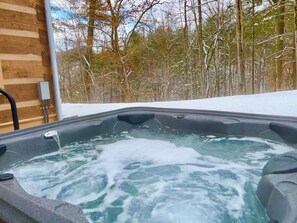Relax in a forest-view hot tub, perfect for starry nights or morning dips