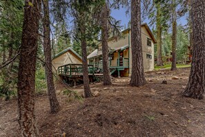 Exterior: View of the back of the home, private backyard, wooded area, deck