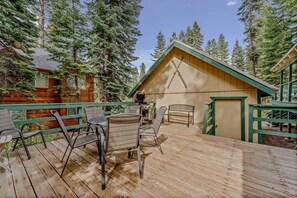 Exterior: Spacious deck, outdoor dining, gas BBQ, wooded surroundings