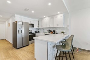 A fully equipped kitchen with quality stainless steel appliances