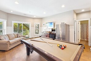 The Wet Bar makes snacks easy in the recreation room with a Pool Table and Arcade Gaming System!