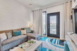 Living room with a full & twin sofa sleeper, Smart TV, and balcony