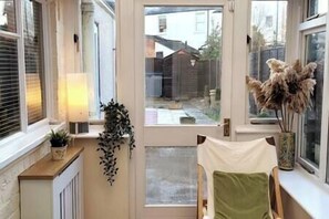 A small, but lovely conservatory opens onto a garden patio area, ideal for relaxing (1)