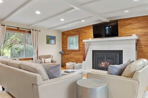 Spacious yet cozy living room with comfortable furniture and a beautiful gas fireplace