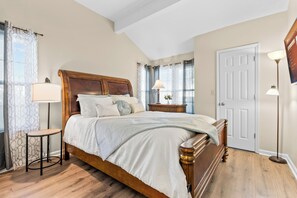Primary bedroom features a cozy queen-size bed with linens and pillows for a restful night’s sleep