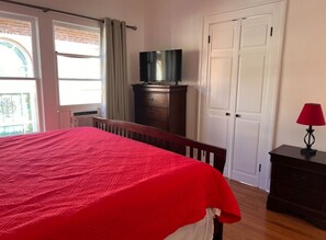 King bed. Twin bed located behind French doors.
