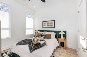 Primary Bedroom featuring a Queen bed, designer furnishings, a walk-in closet, and en-suite bathroom.